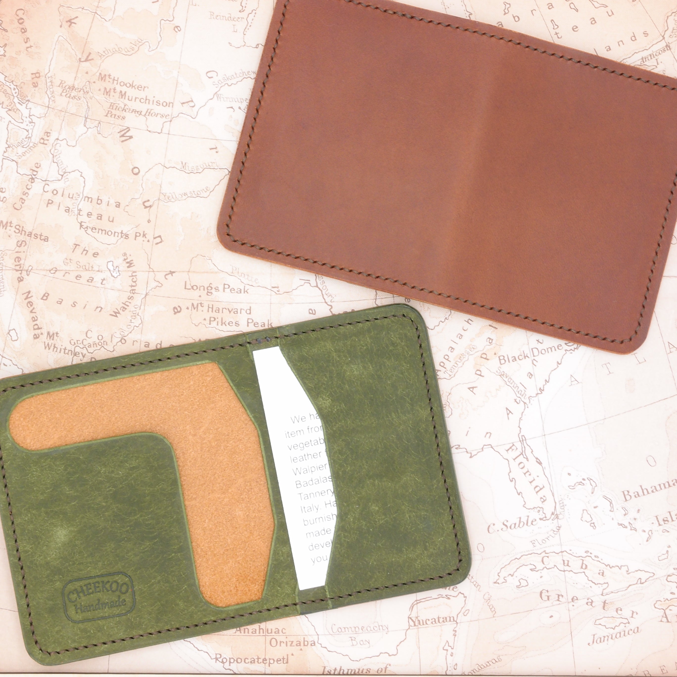 Two wallets in mahogany or green colors made of full grain vegetable tanned leather