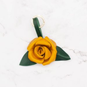 yellow leather rose with two green leaves and one brass keyring